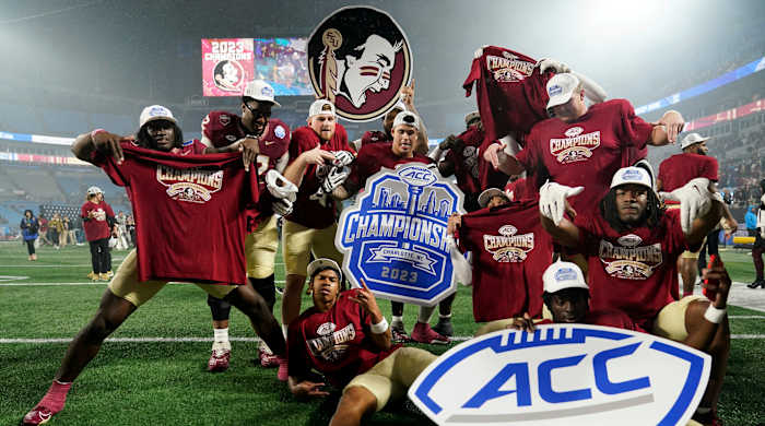 Florida State football players pose in celebration after winning the ACC championship.